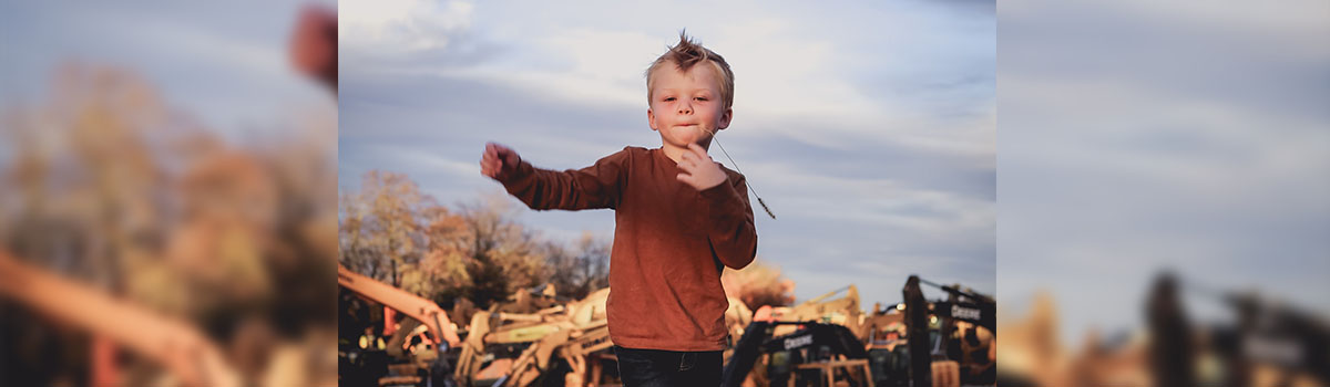 jake in a field with a tractor