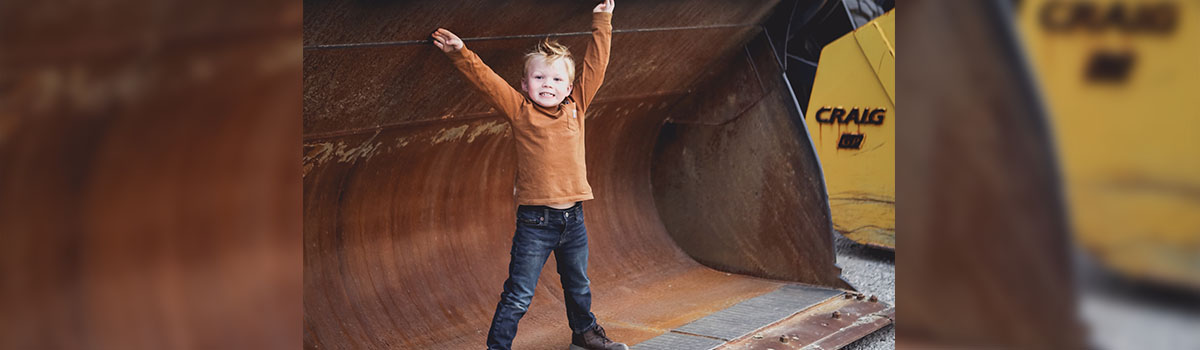 jake playing in a large dozer bucket